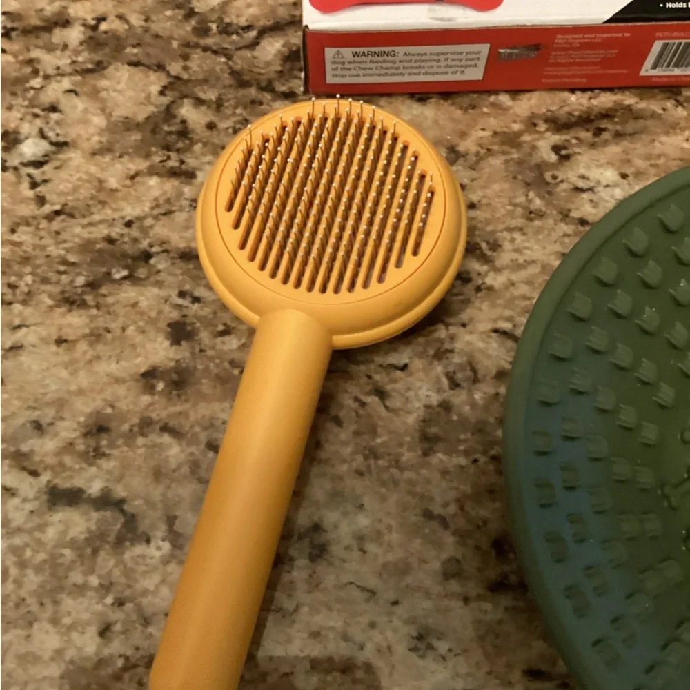 Dog brush, dog bowl and chew champ